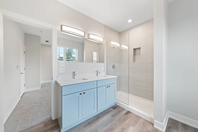 a bathroom with a double vanity sink and a mirror