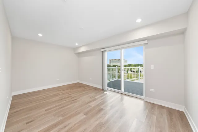 a bedroom with a large bed and a potted plant