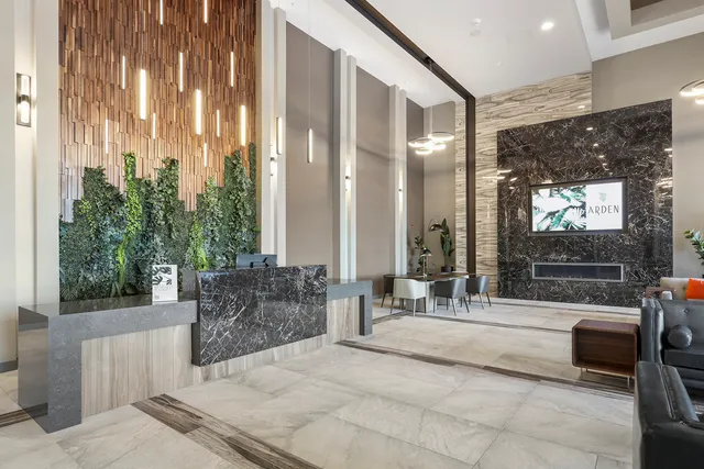 a living room with furniture potted plant and a large window