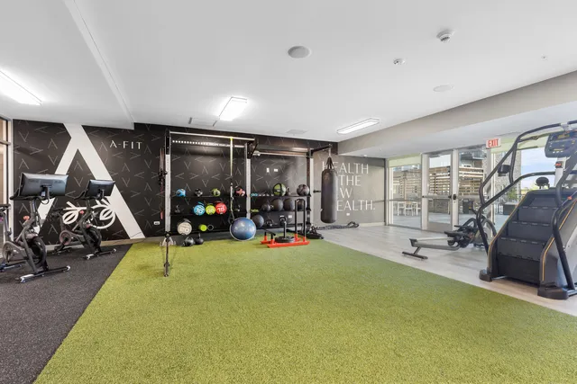 a view of a room with gym equipment and a large window
