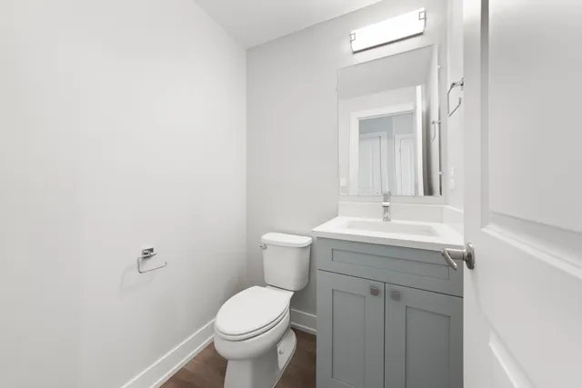 a bathroom with a sink toilet and mirror