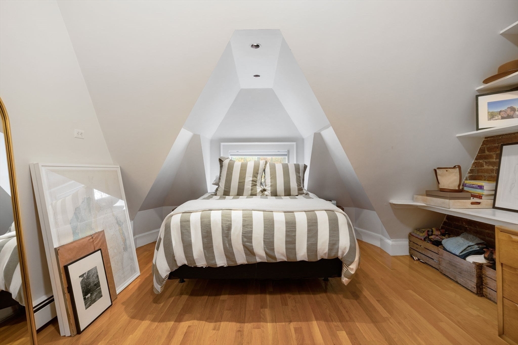 1778 Beacon Street, Unit 302 Brookline, MA 02445 - Photo 13 of 18 a bedroom with a bed and wooden floor