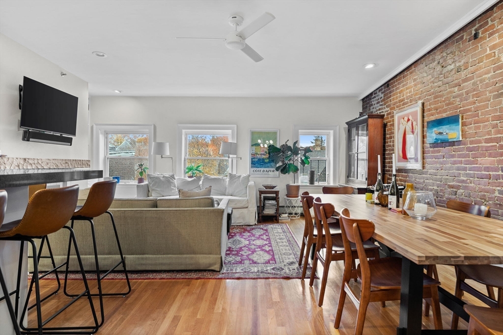 1778 Beacon Street, Unit 302 Brookline, MA 02445 - Photo 6 of 18 a living room with furniture a flat screen tv and a large window