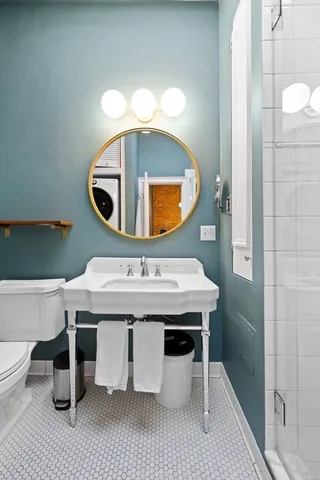 a bathroom with a sink a mirror and vanity