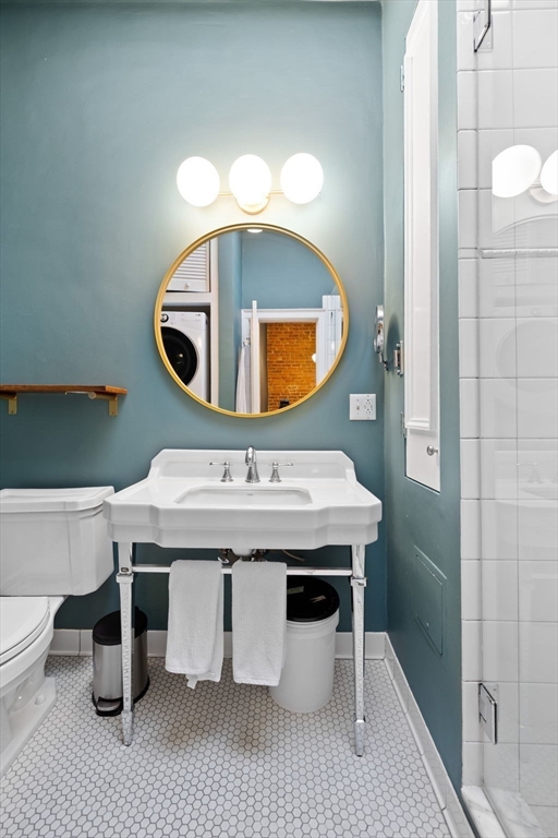 1778 Beacon Street, Unit 302 Brookline, MA 02445 - Photo 10 of 18 a bathroom with a sink a mirror and vanity