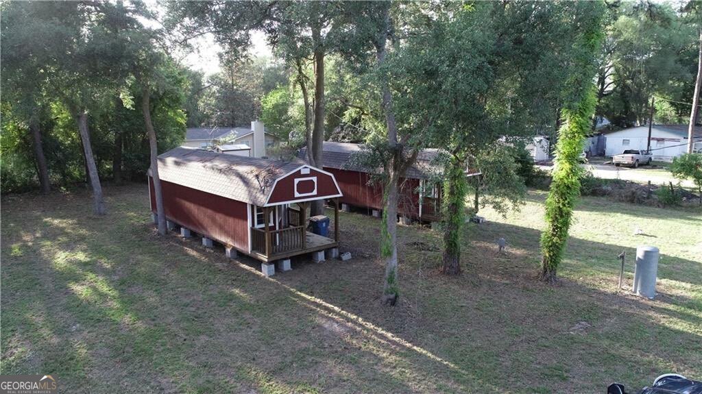 41 Middle Road Hortense, GA 31543 - Photo 16 of 22 a view of a wooden house with a yard and large trees