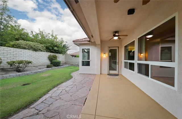 a view of a porch with a table and chairs