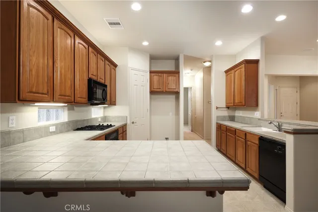 a kitchen with stainless steel appliances granite countertop a sink and a stove