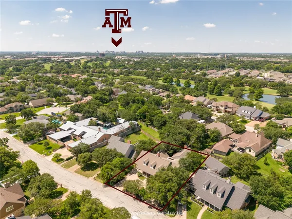an aerial view of residential houses with city view
