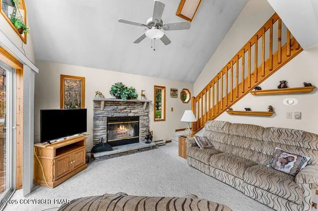 a living room with furniture a flat screen tv and a fireplace