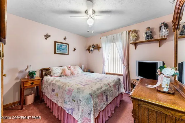 a bedroom with a bed and a table in it