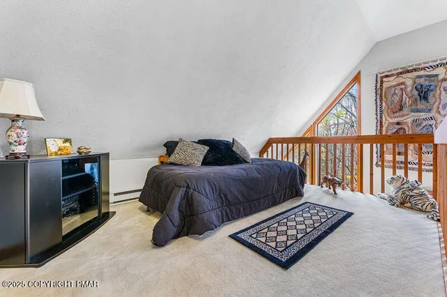 a bedroom with furniture and a window