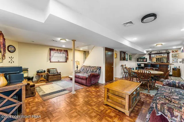 a living room with furniture and a dining table