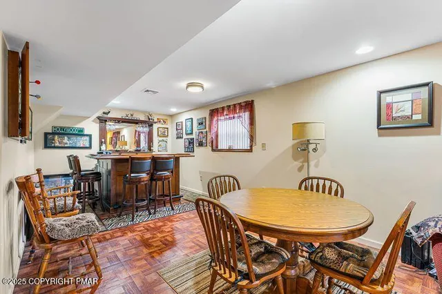 a room with lots of furniture and painting on the wall