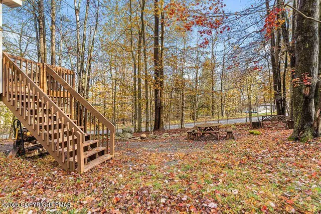 a backyard of a house with table and chairs