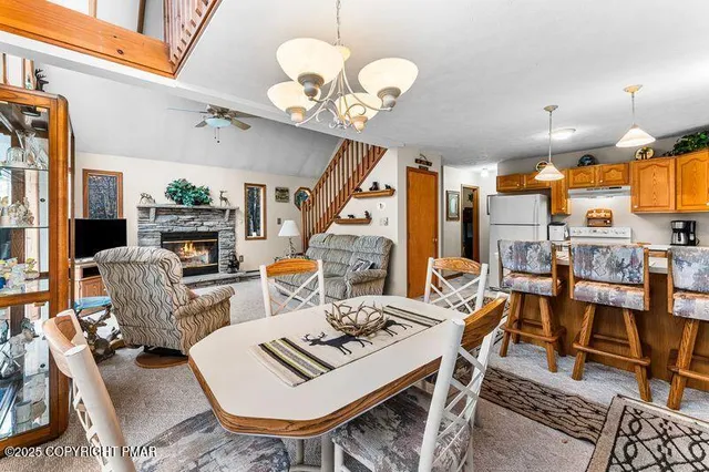a view of a dining room with furniture a chandelier and wooden floor