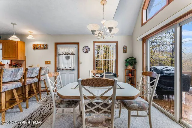 a view of a dining room with furniture window and outside view