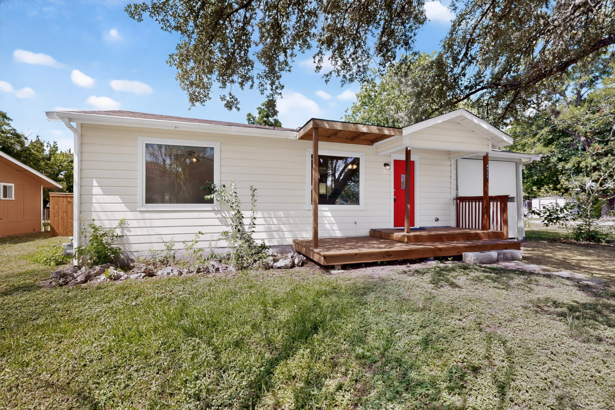 4711 Alf Avenue Austin, TX 78721 - Photo 2 of 34 A welcoming front porch with a vivid red entry door enhances this charming residence's curb appeal.