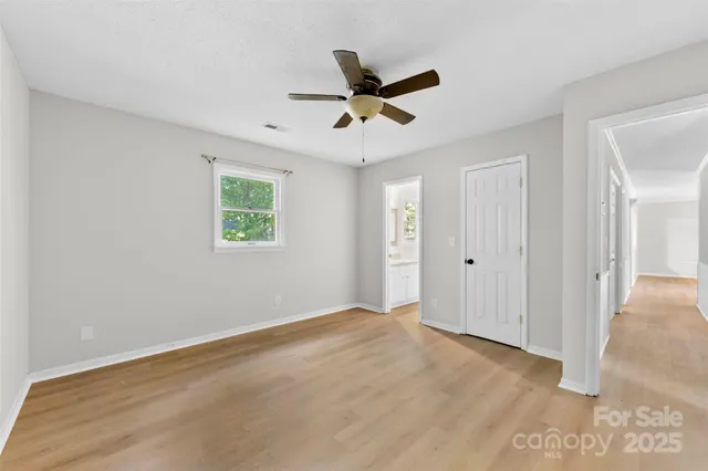 a view of a livingroom with a ceiling fan and window
