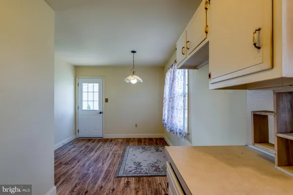 a view of a livingroom with wooden floor and staircase