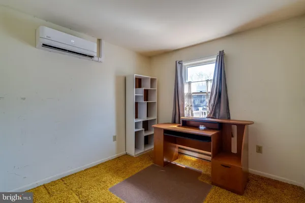 a living room with a bed furniture and a window