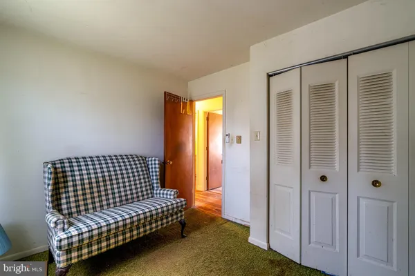 a view of a bedroom with wooden floor & cabinet