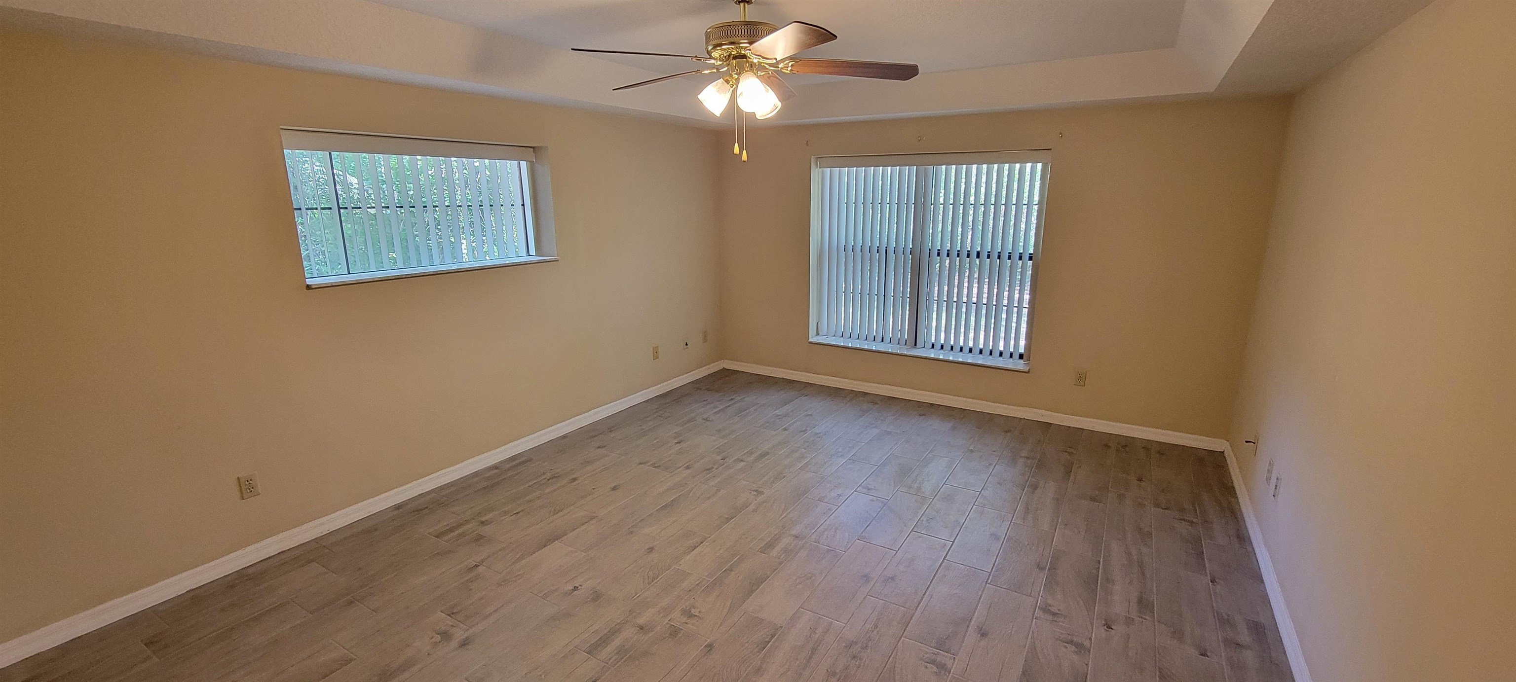 305 Raintree Trail St. Augustine, FL 32086 - Photo 14 of 19 a view of an empty room with wooden floor and a window