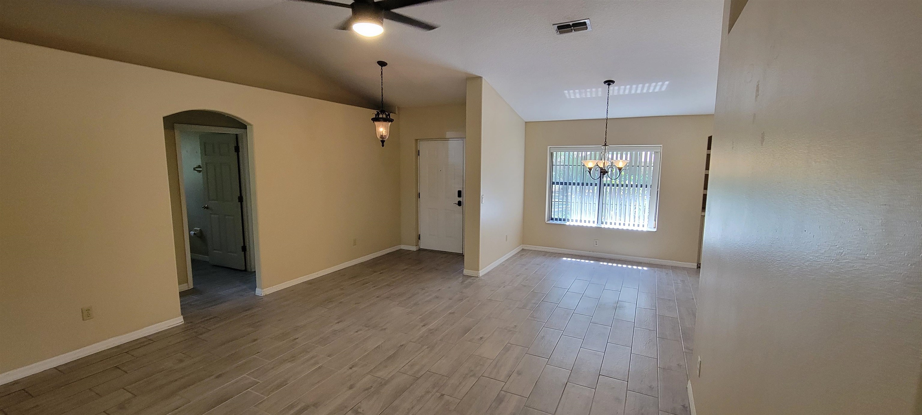 305 Raintree Trail St. Augustine, FL 32086 - Photo 8 of 19 wooden floor in an empty room with a window