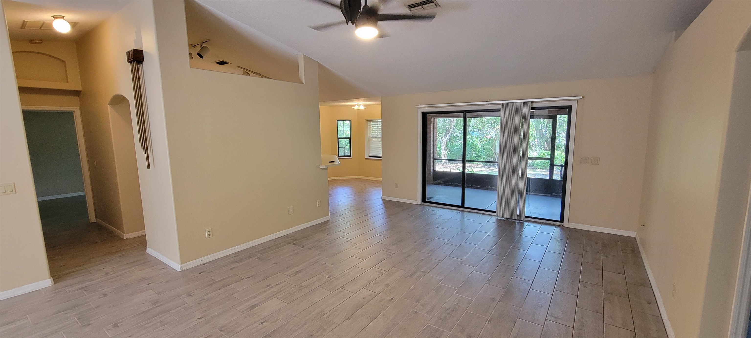 305 Raintree Trail St. Augustine, FL 32086 - Photo 10 of 19 an empty room with wooden floor and a ceiling fan