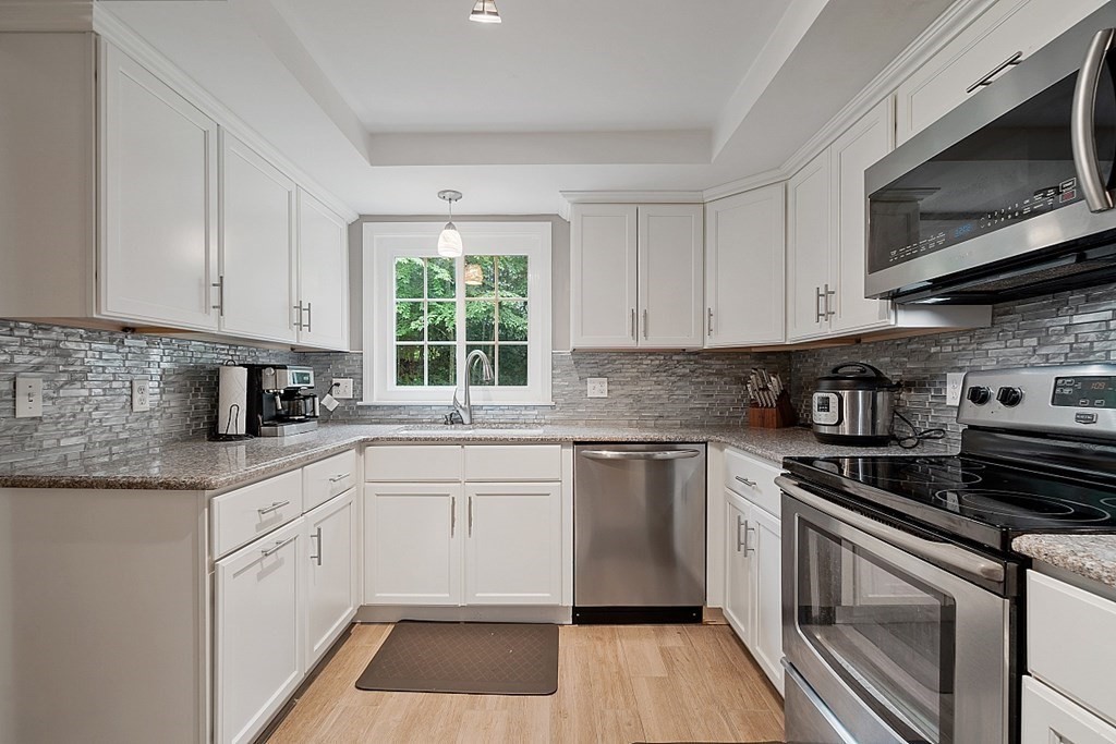473 Main Street Boxford, MA 01921 - Photo 12 of 42 a kitchen with cabinets appliances a sink and a window