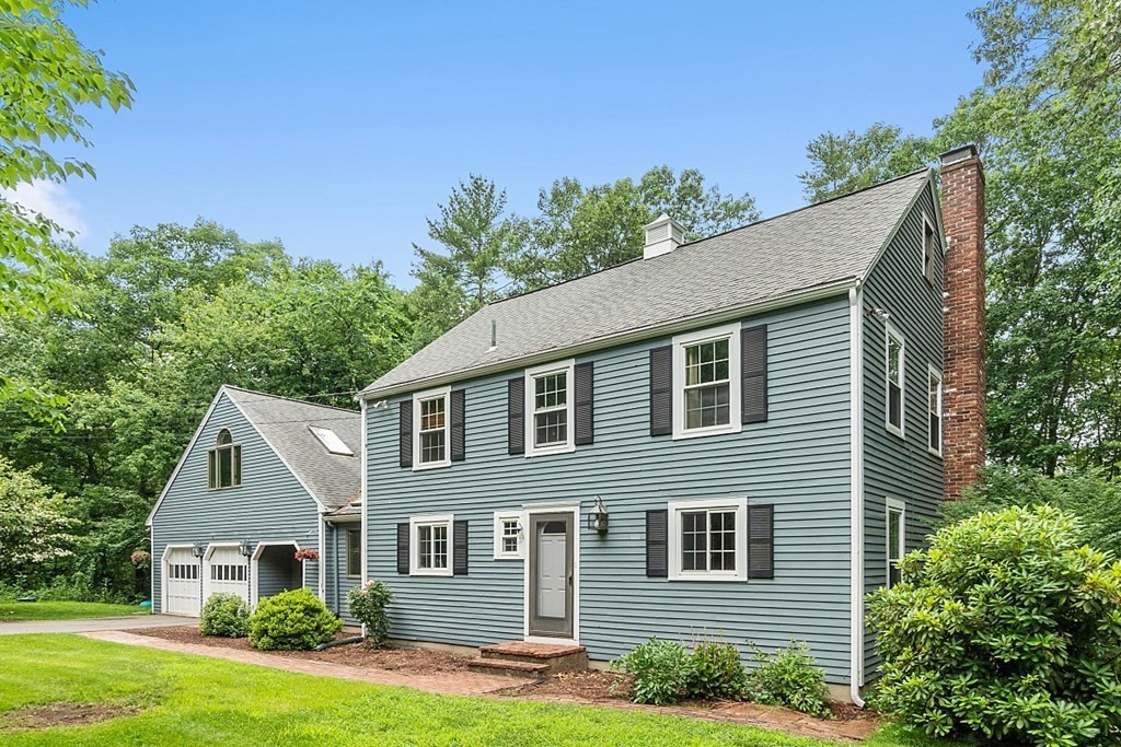 473 Main Street Boxford, MA 01921 - Photo 2 of 42 a front view of a house with a yard and garage