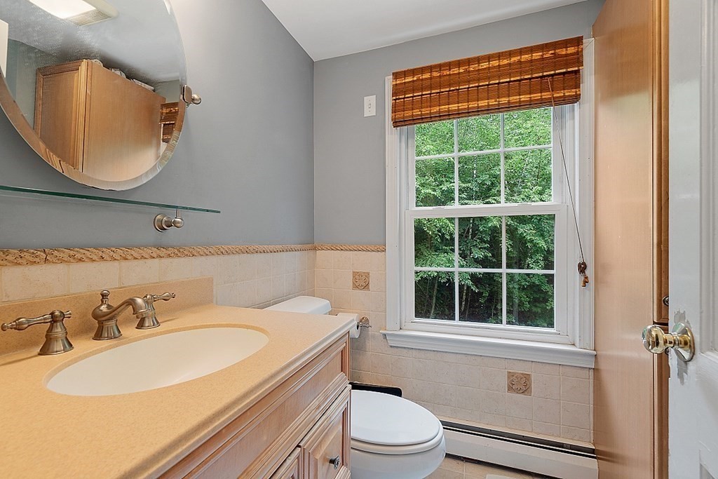 473 Main Street Boxford, MA 01921 - Photo 23 of 42 a bathroom with a sink a toilet and a mirror