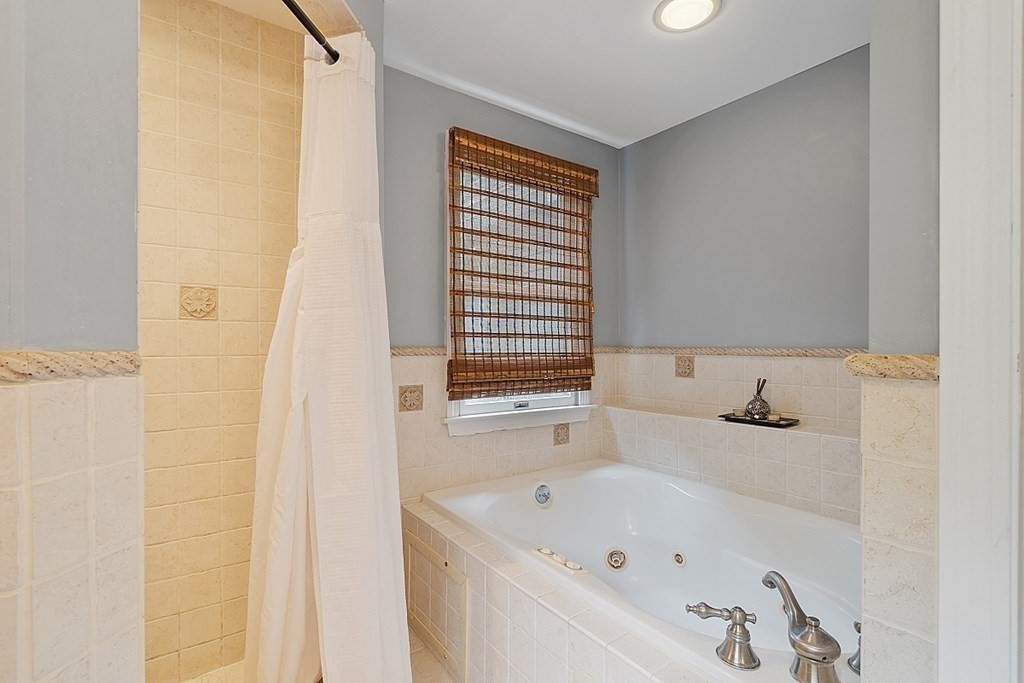 473 Main Street Boxford, MA 01921 - Photo 24 of 42 a bathroom with a bathtub and a sink