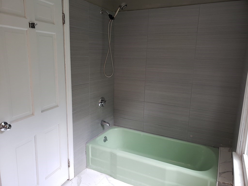 473 Main Street Boxford, MA 01921 - Photo 30 of 42 a bathroom with a bathtub and a shower