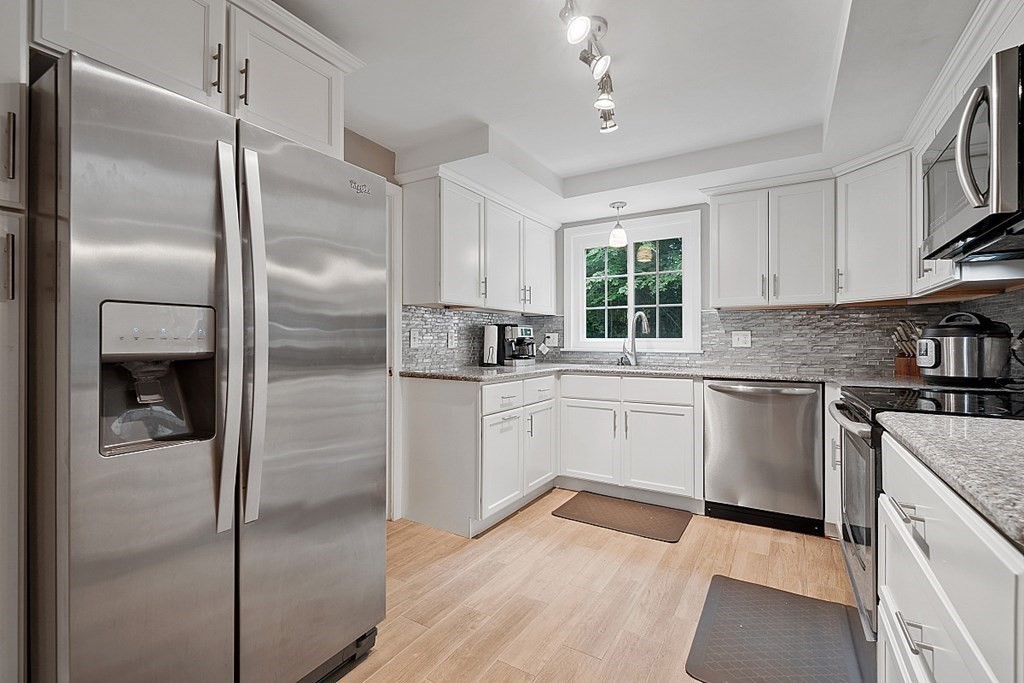 473 Main Street Boxford, MA 01921 - Photo 10 of 42 a kitchen with a refrigerator a sink stainless steel appliances and cabinets