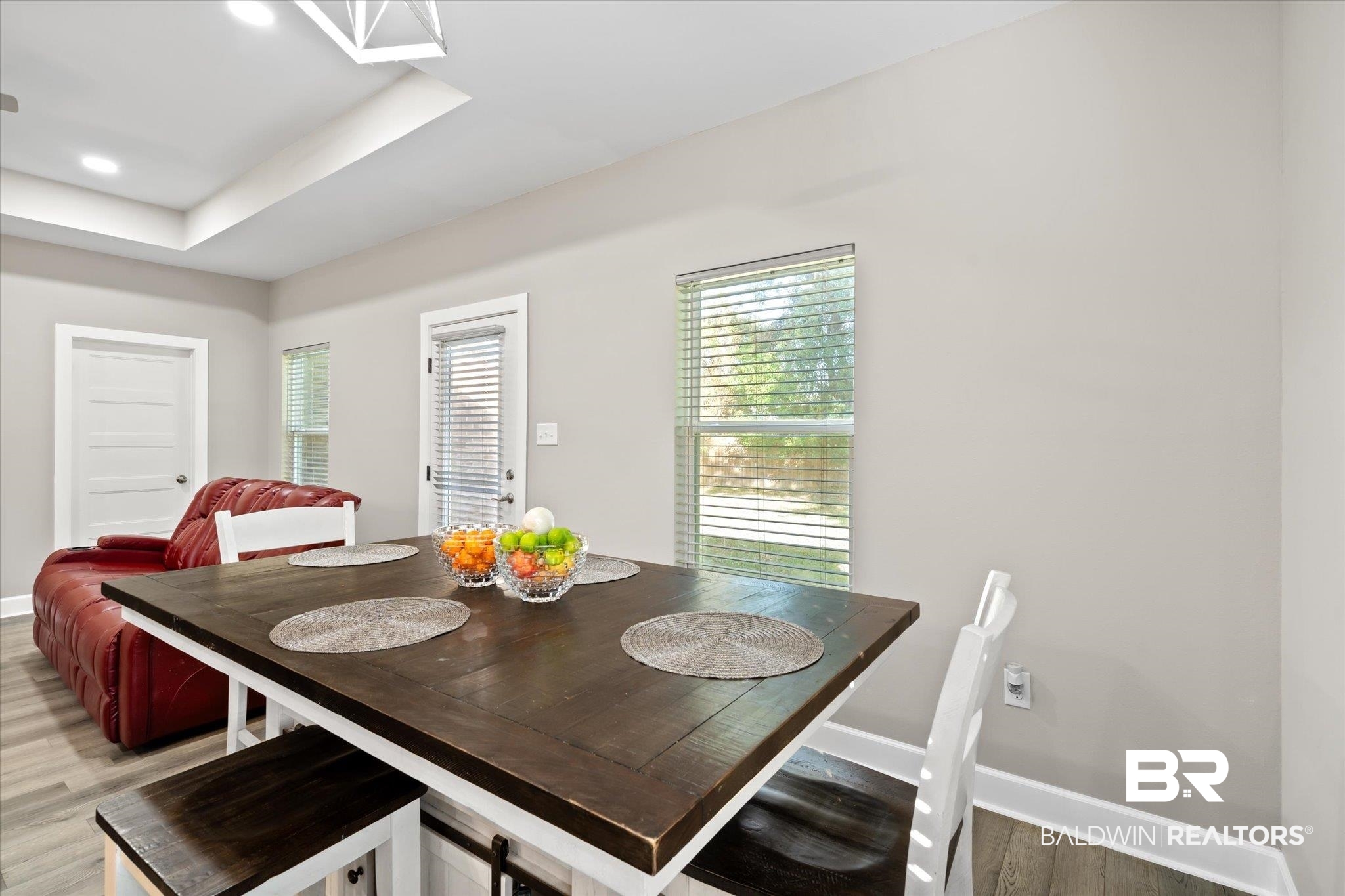 708 Fisher Street Mobile, AL 36607 - Photo 8 of 17 Dining room featuring a tray ceiling and wood-type flooring