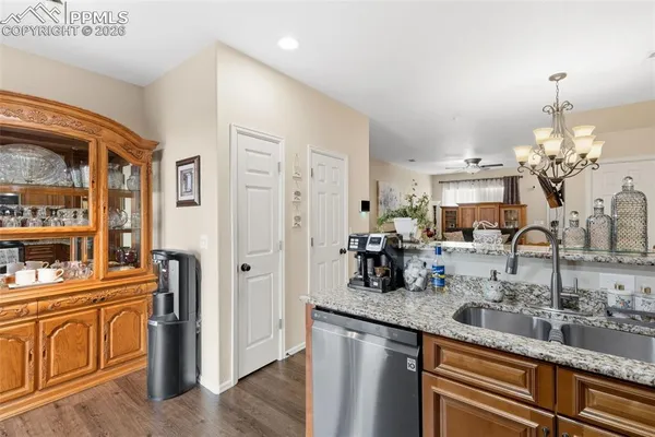 a kitchen with counter top space and living room view