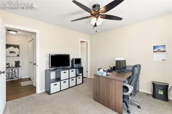 a view of a livingroom with workspace and a window