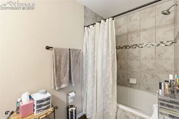 a bathroom with a shower curtain and a sink