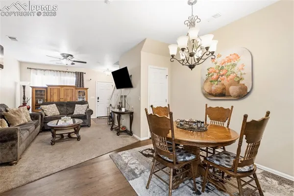 a view of a dining room with furniture and chandelier