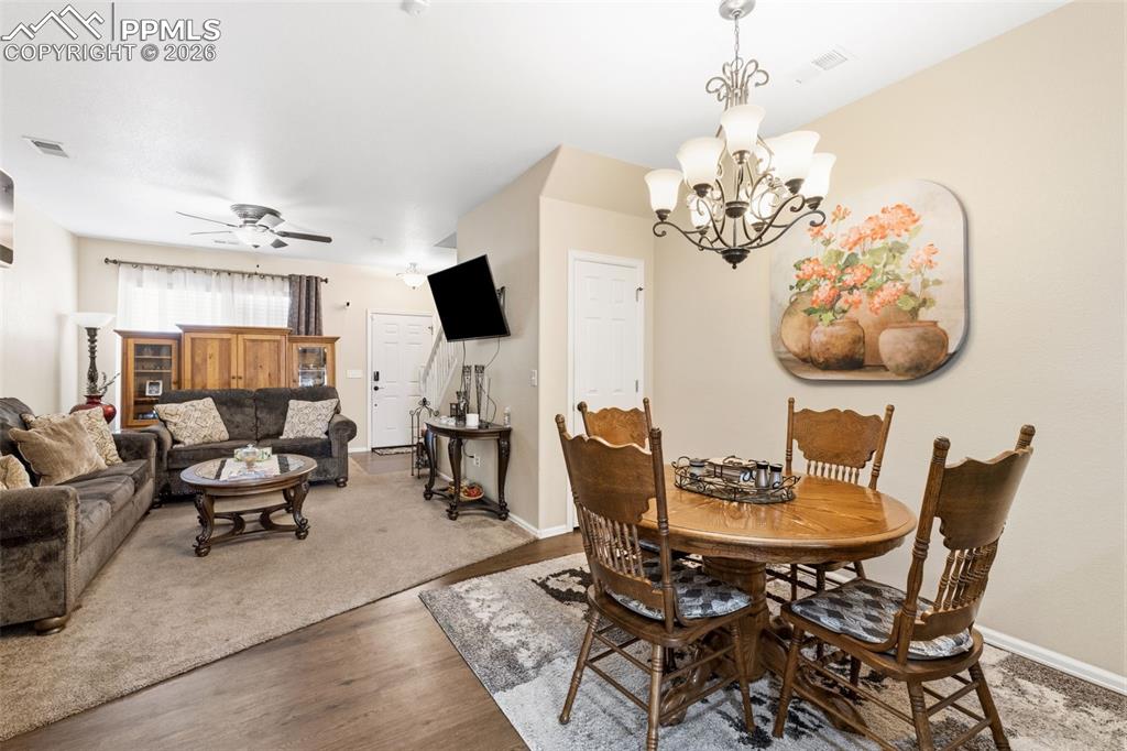 3519 Grey Owl Point Colorado Springs, CO 80916 - Photo 7 of 29 Dining room featuring suspended lighting, wood finished floors, and ceiling fan