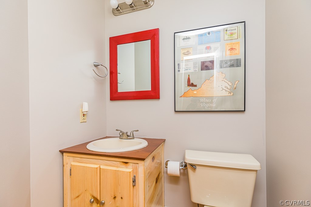 3433 Hales Point Road Farnham, VA 22460 - Photo 27 of 32 a bathroom with a toilet sink and mirror