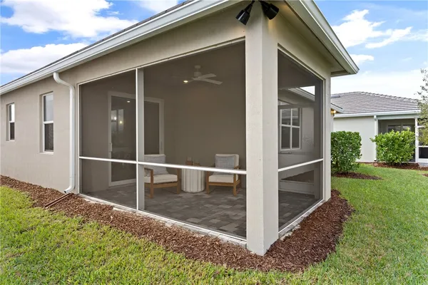 a backyard of a house with wooden floor and fence
