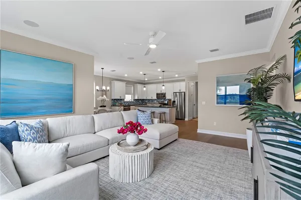 a living room with furniture and kitchen view
