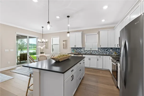 a kitchen with a sink stove and refrigerator