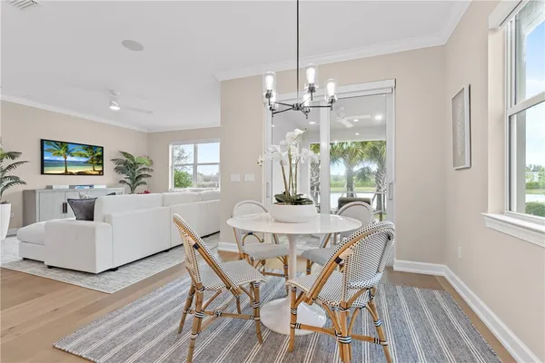 a view of a dining room with furniture window and wooden floor