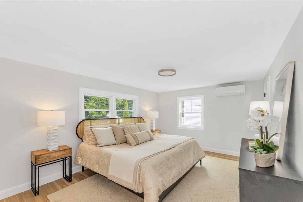 26 Crehore Road Boston, MA 02467 - Photo 17 of 33 a bedroom with a bed and a potted plant