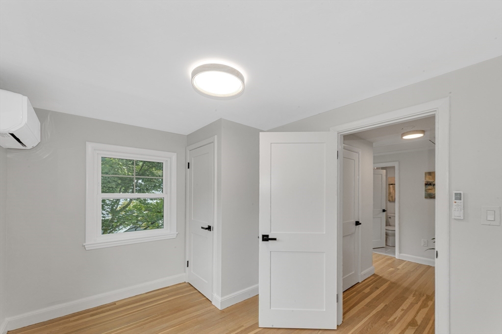 26 Crehore Road Boston, MA 02467 - Photo 21 of 33 a view of hallway with window and wooden floor