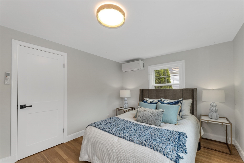 26 Crehore Road Boston, MA 02467 - Photo 25 of 33 a bedroom with a bed and wooden floor