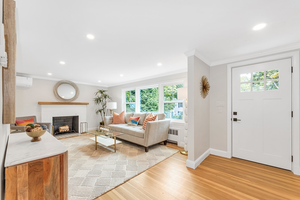 26 Crehore Road Boston, MA 02467 - Photo 3 of 33 a living room with furniture and a fireplace